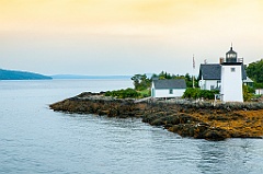 Sun Filters Through Clouds at Grindle Point Light at Low tide